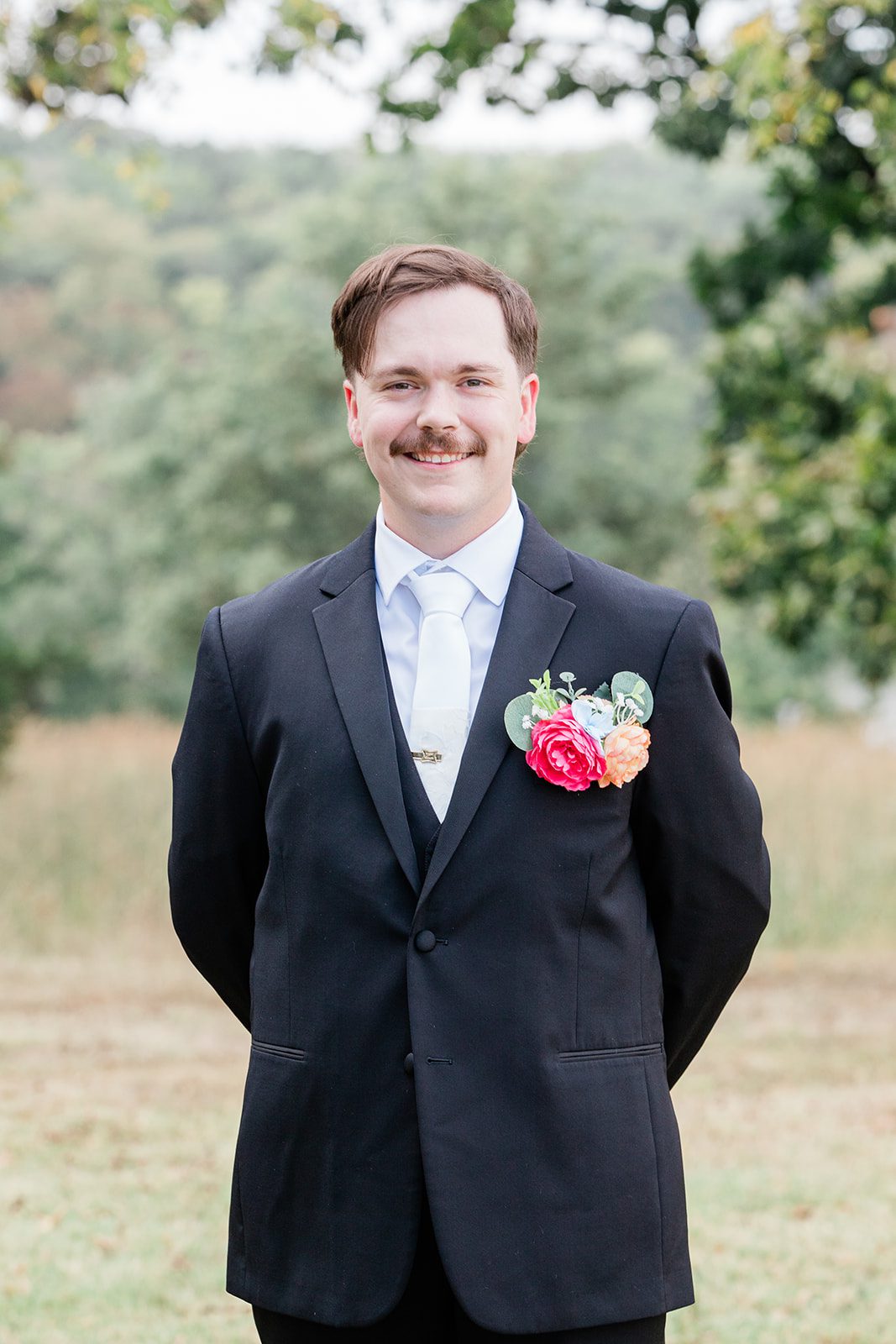 innsbrook-resort-airy-st-louis-sophia-brendan-p016-09 Groom smiling with his pink boutonniere