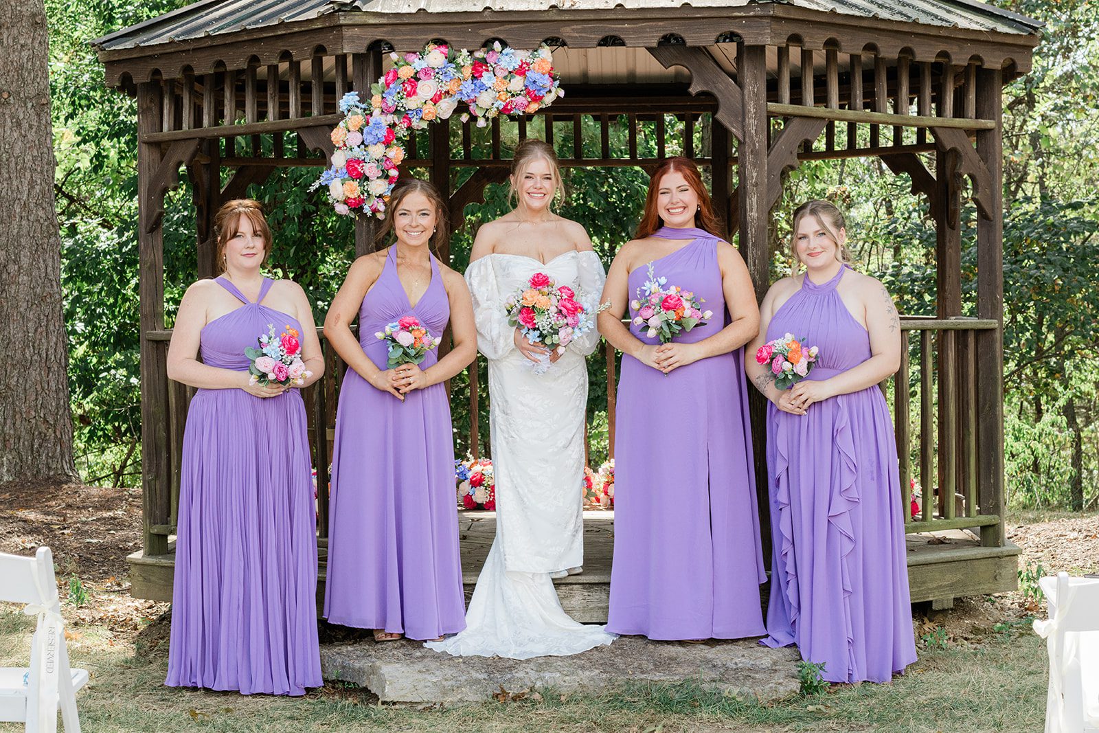 innsbrook-resort-airy-st-louis-sophia-brendan-p033-08 Bridesmaids in purple dresses at the gazebo