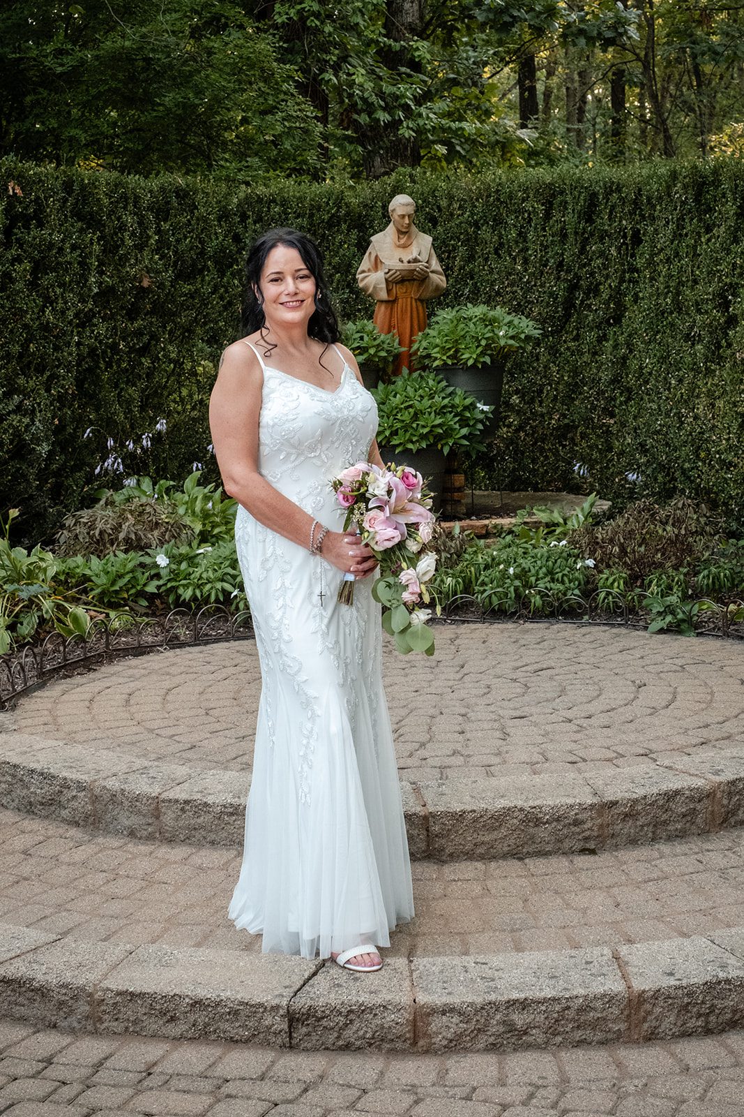 Bride standing in the garden at Krapil’s Steakhouse Bride standing in the garden at Krapil’s Steakhouse