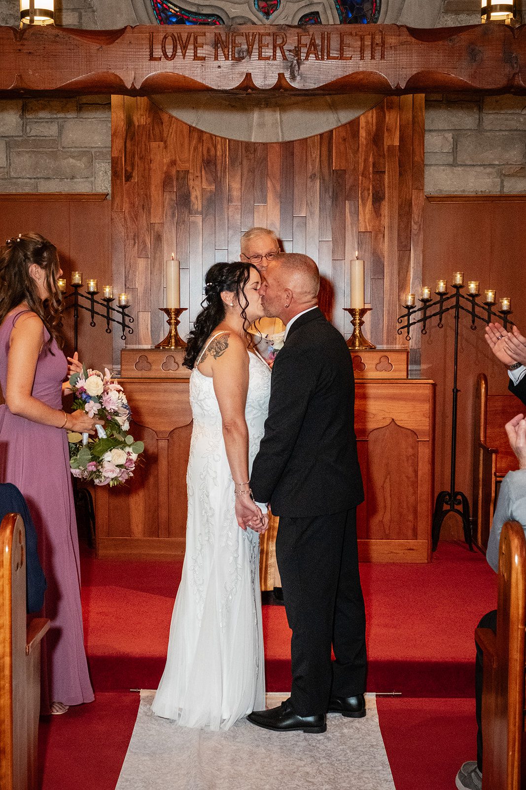 Couple holding hands at the altar Couple holding hands at the altar