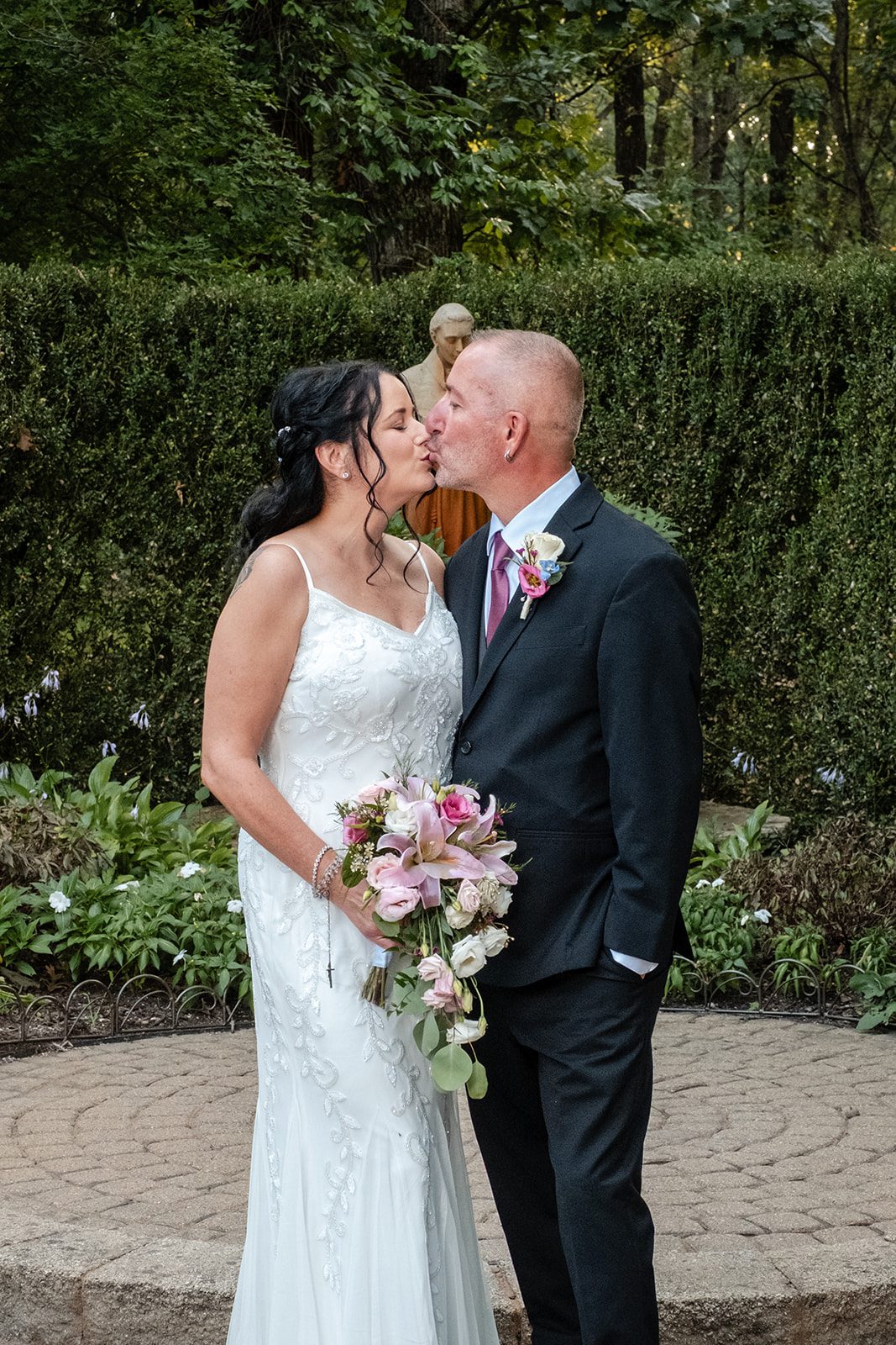 Couple sharing a kiss in the garden Couple sharing a kiss in the garden