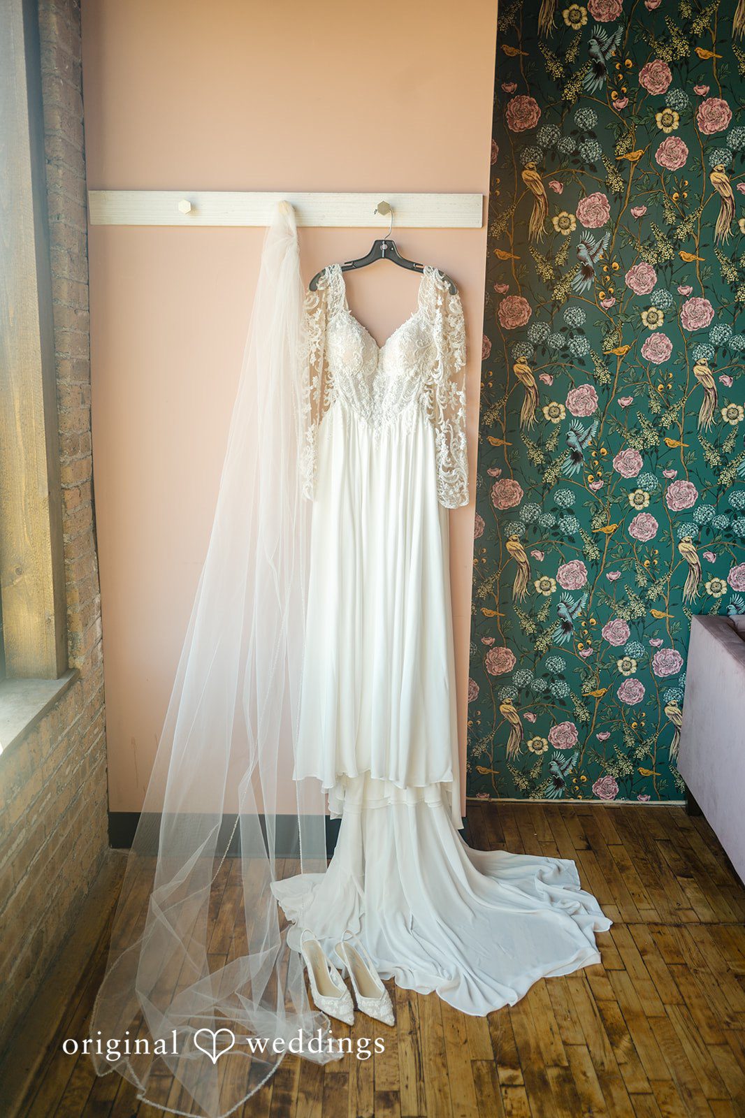 Michael + Haley Wedding gown hanging by the window at Lacuna Lofts
