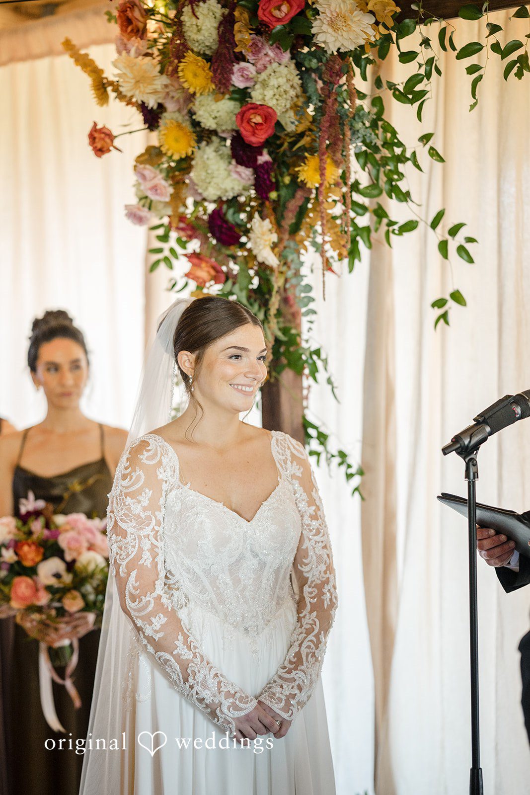Michael + Haley Bride under the floral arch at Lacuna Lofts
