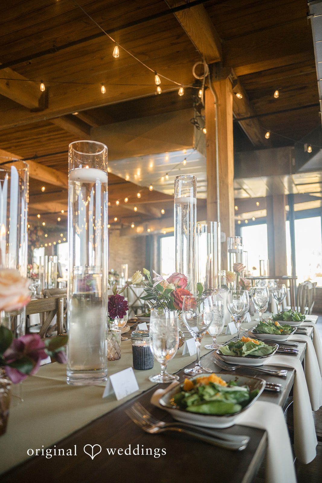 Michael + Haley Reception tables glowing with candlelight at Lacuna Lofts