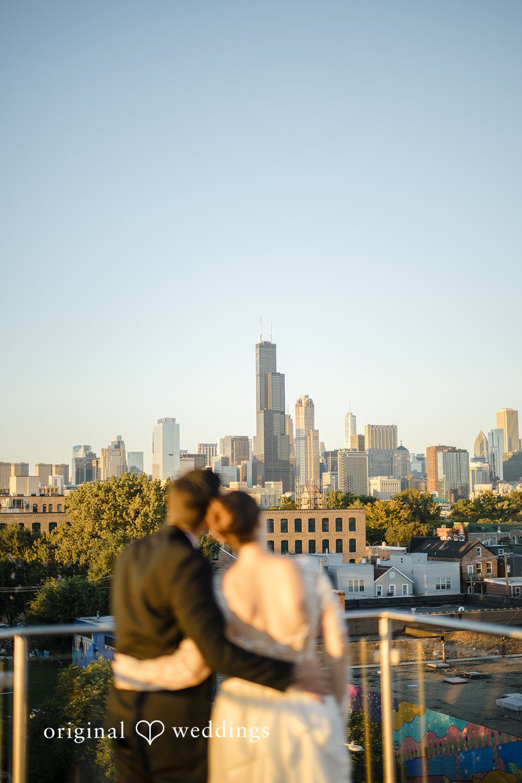 Michael + Haley Couple with the Chicago skyline behind them, captured by Chicago wedding photographers from Original Weddings
