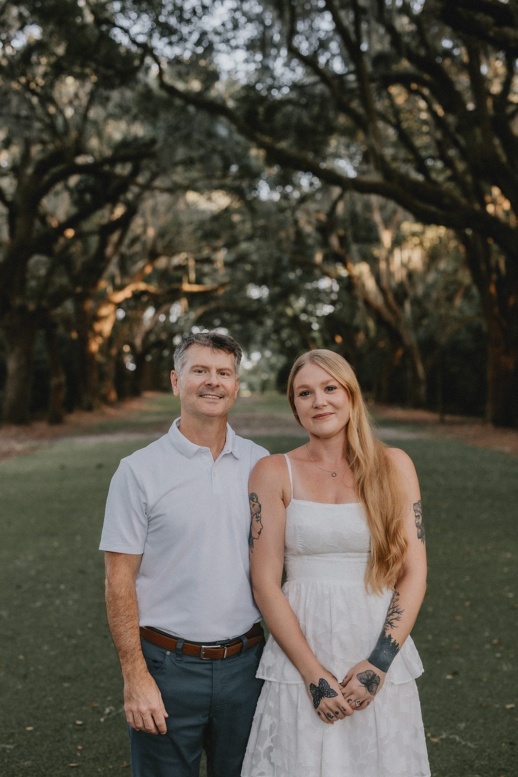 legare-waring-house-rustic-charleston-kaylee-nick-p007-13 Couple smiling at the camera under the trees at Legare Waring House