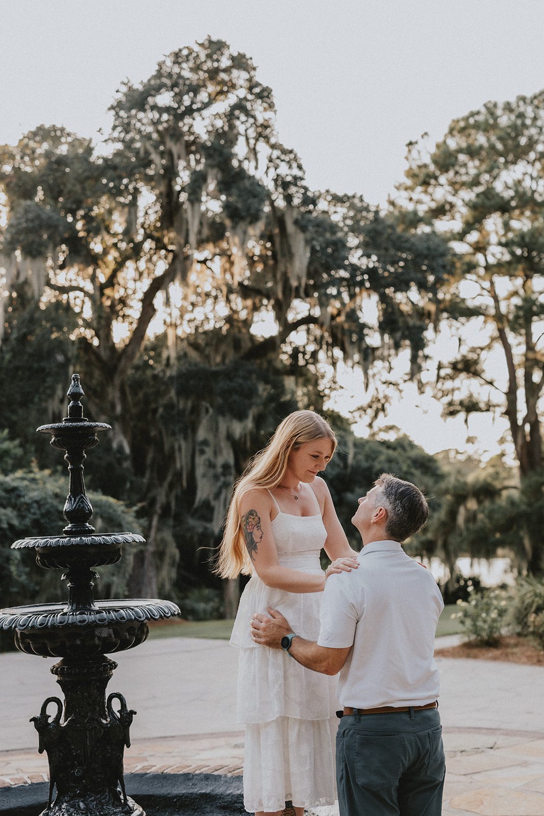 legare-waring-house-rustic-charleston-kaylee-nick-p012-09 Couple posing by the garden fountain at Legare Waring House