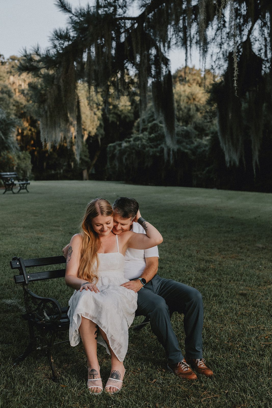 legare-waring-house-rustic-charleston-kaylee-nick-p016-12 Engaged couple sharing a kiss on the lawn
