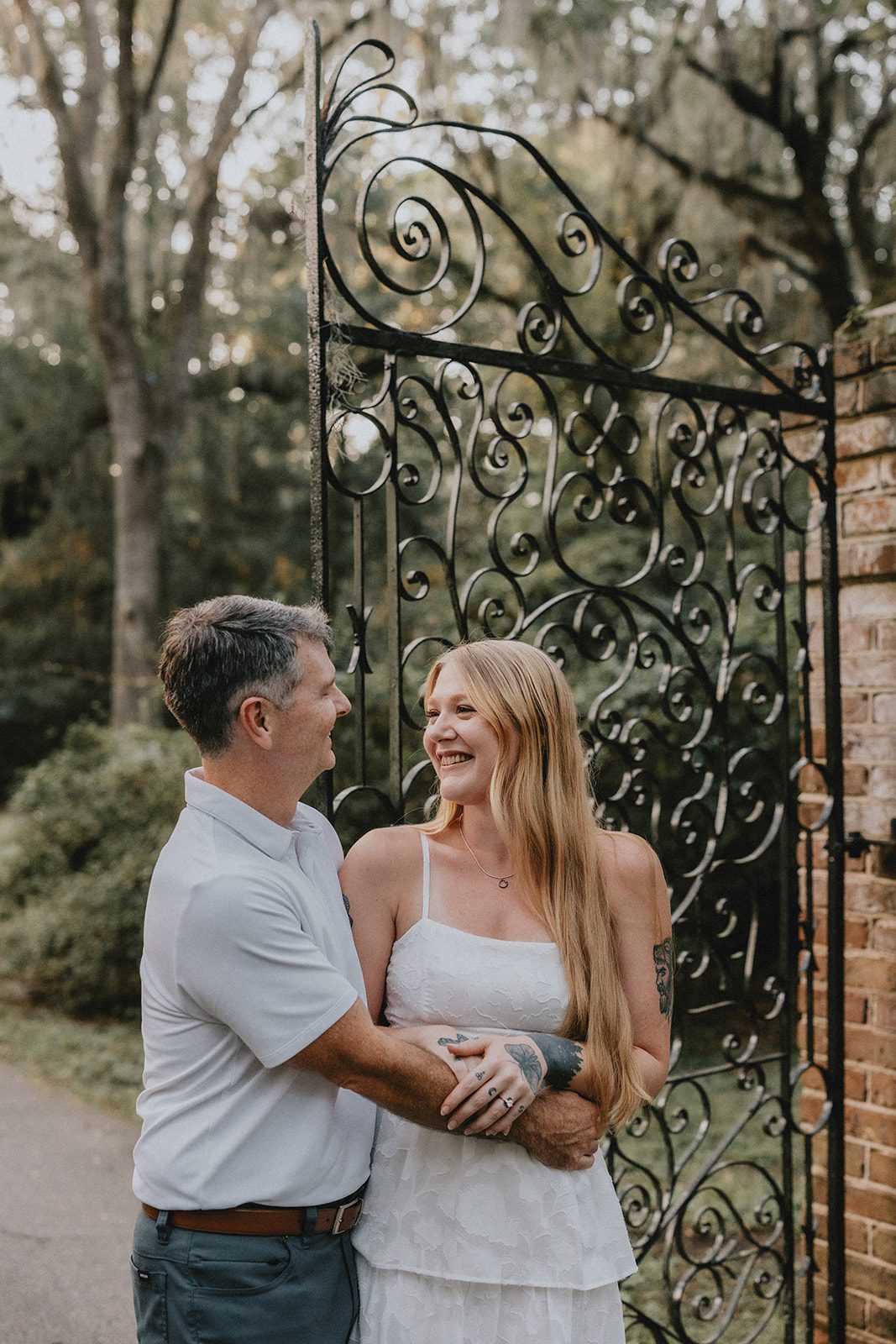 legare-waring-house-rustic-charleston-kaylee-nick-p018-10 Couple standing on the oak lined path at Legare Waring House