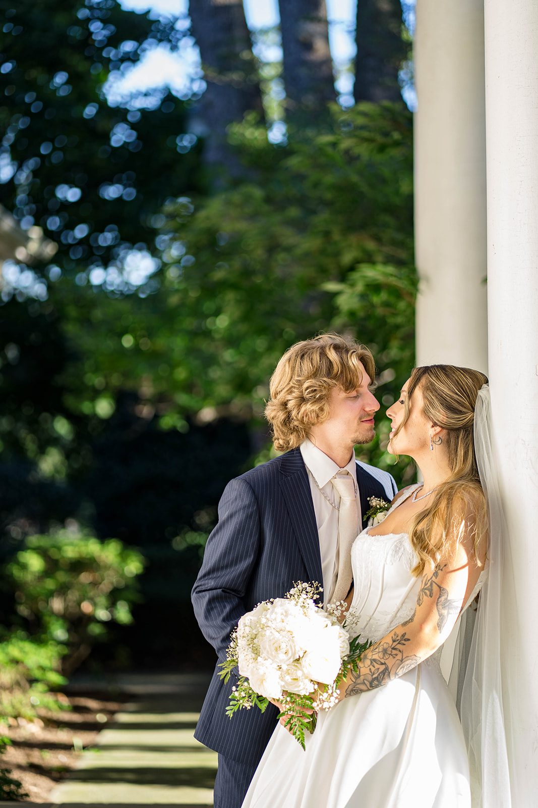 linwood-estate-timeless-baltimore-autumn-dylan-034-23 Couple smiling between the white pillars