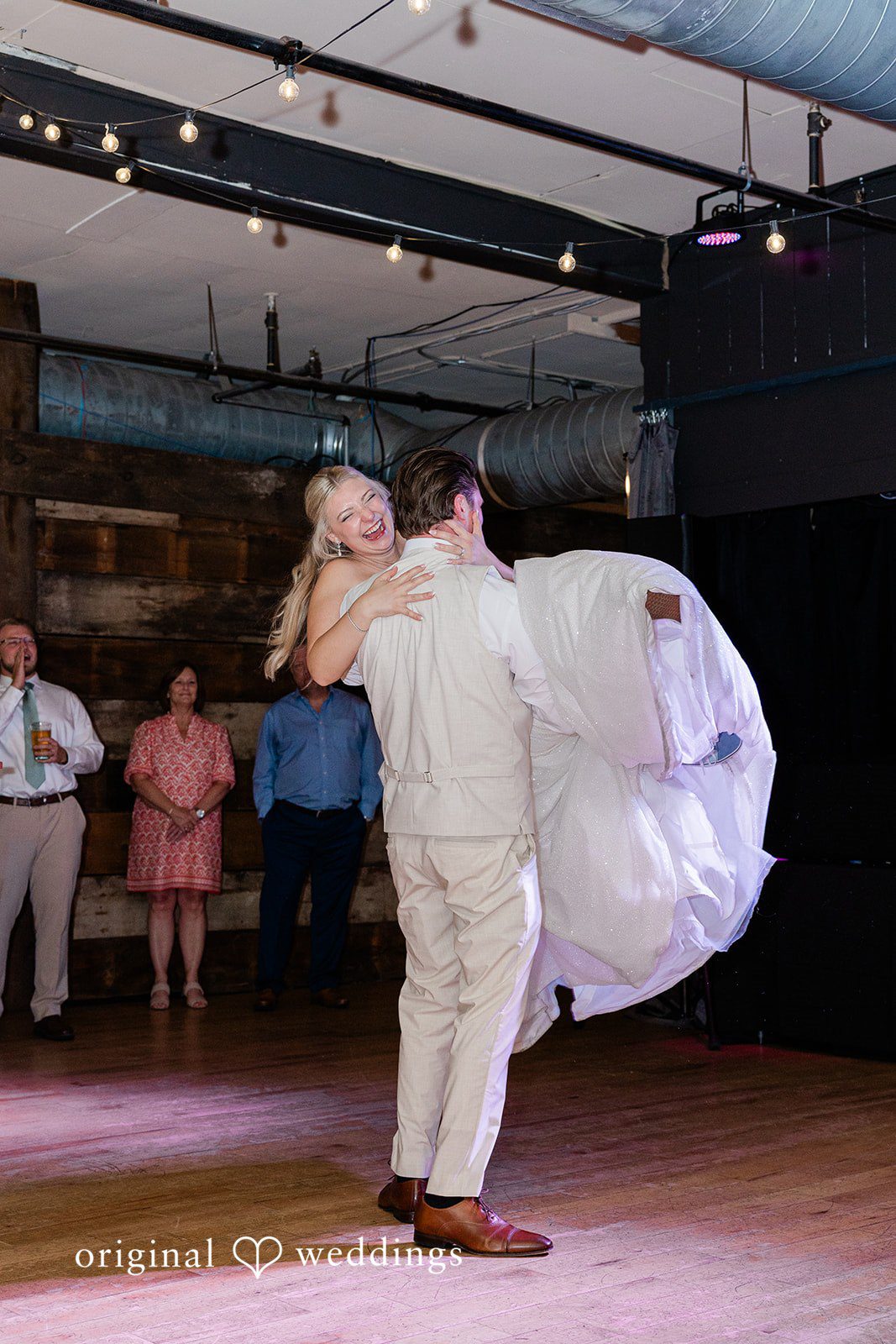 Claire + Alex The groom lifts the bride up