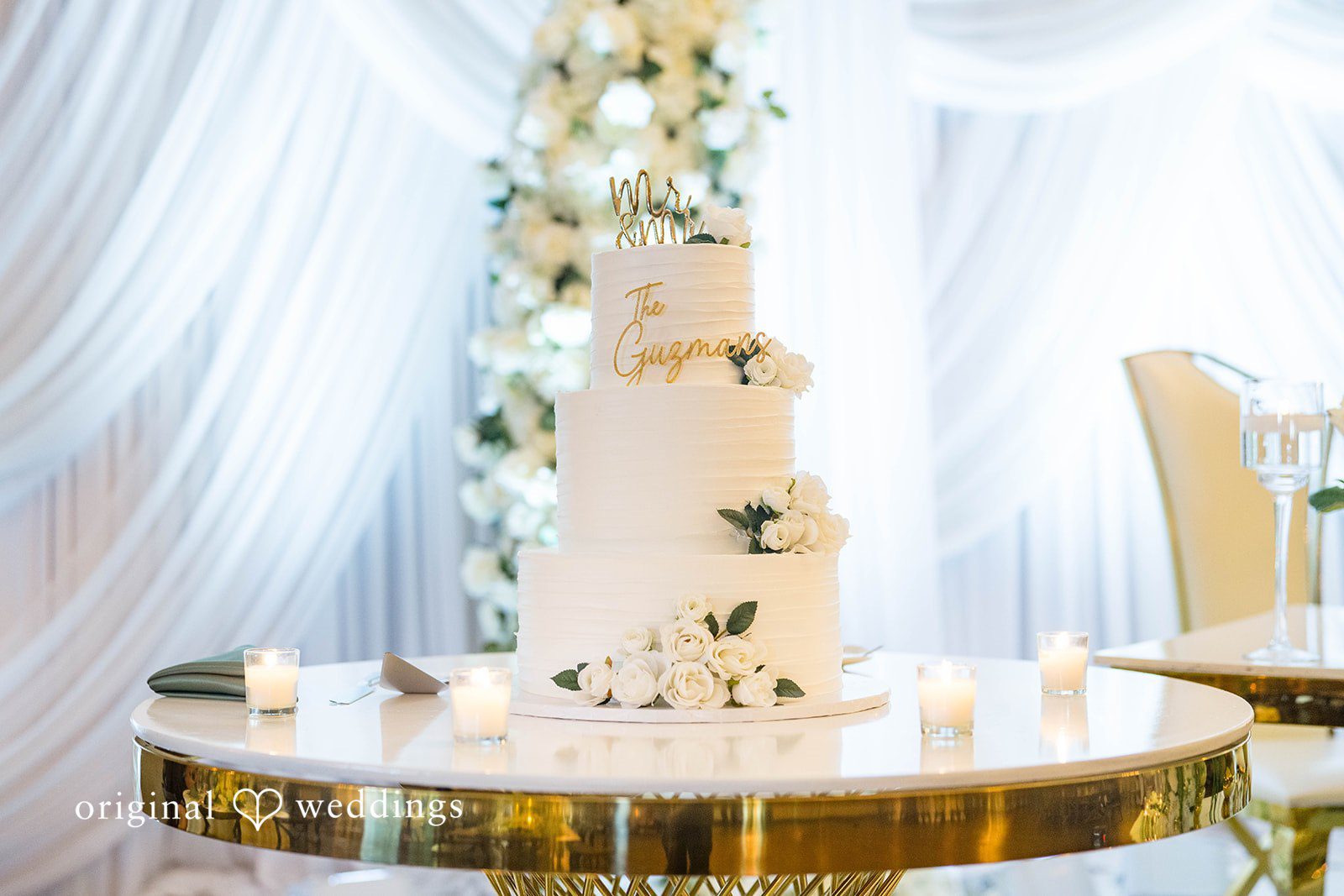 Sierra + Arturo Tiered wedding cake on a gold table at Rancho Los Guzman