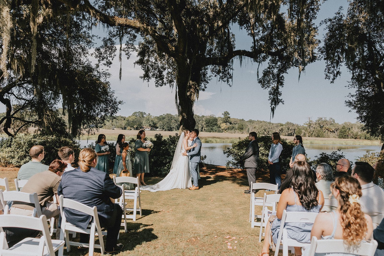 Guests watching the ceremony under the oaks at Magnolia Plantation and Gardens Guests watching the ceremony under the oaks at Magnolia Plantation and Gardens
