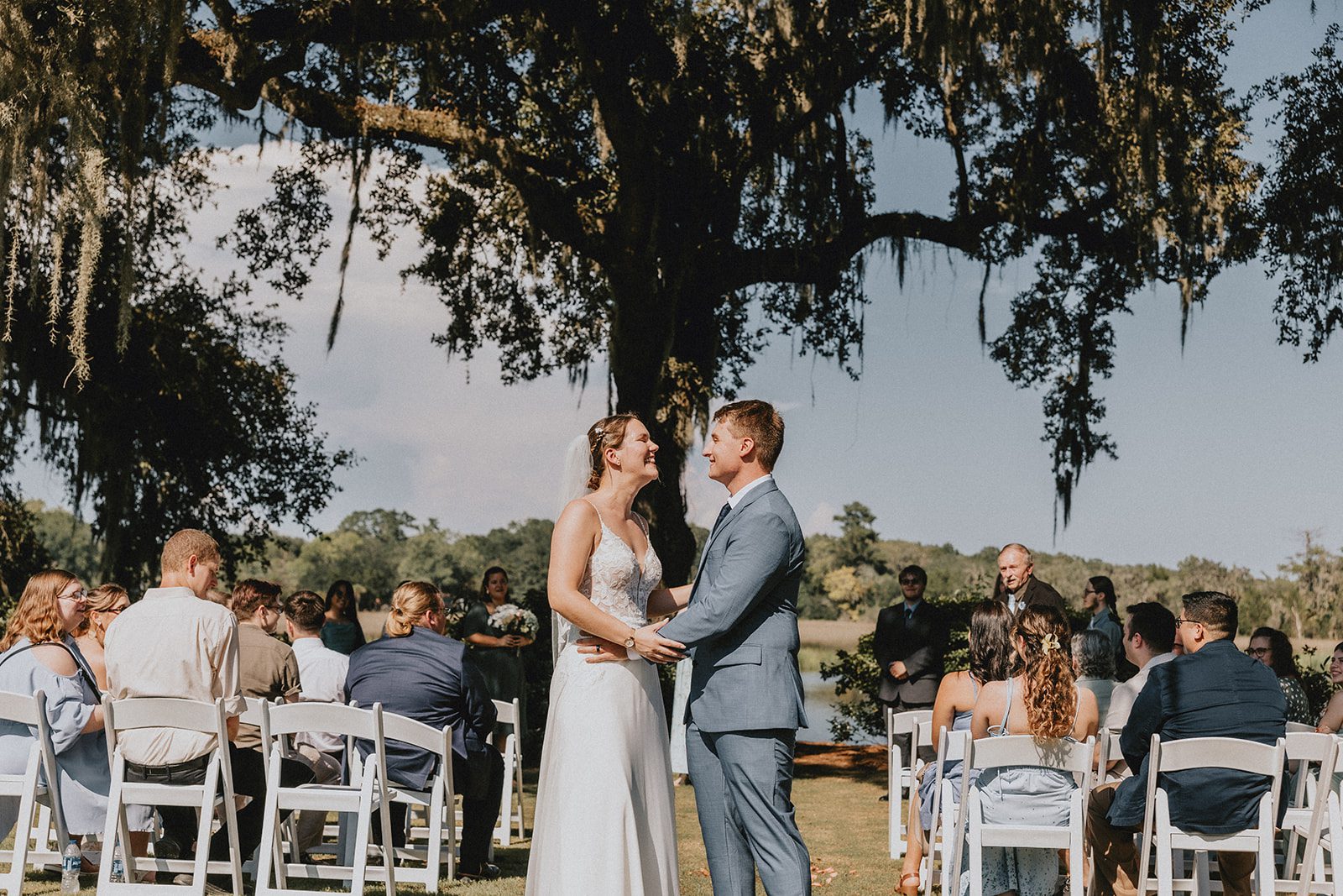 Couple at the ceremony with Spanish moss above Couple at the ceremony with Spanish moss above