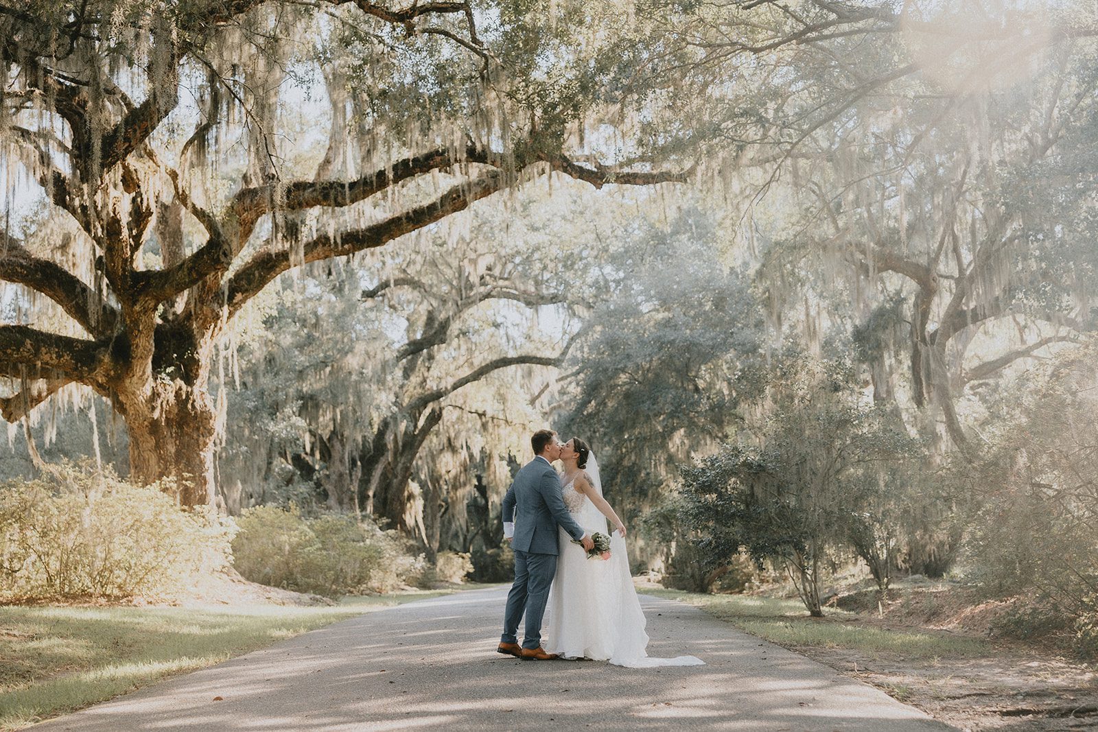 Couple under the moss covered oaks, captured by Charleston wedding photographers from Original Weddings at Magnolia Plantation and Gardens Couple under the moss covered oaks, captured by Charleston wedding photographers from Original Weddings at Magnolia Plantation and Gardens