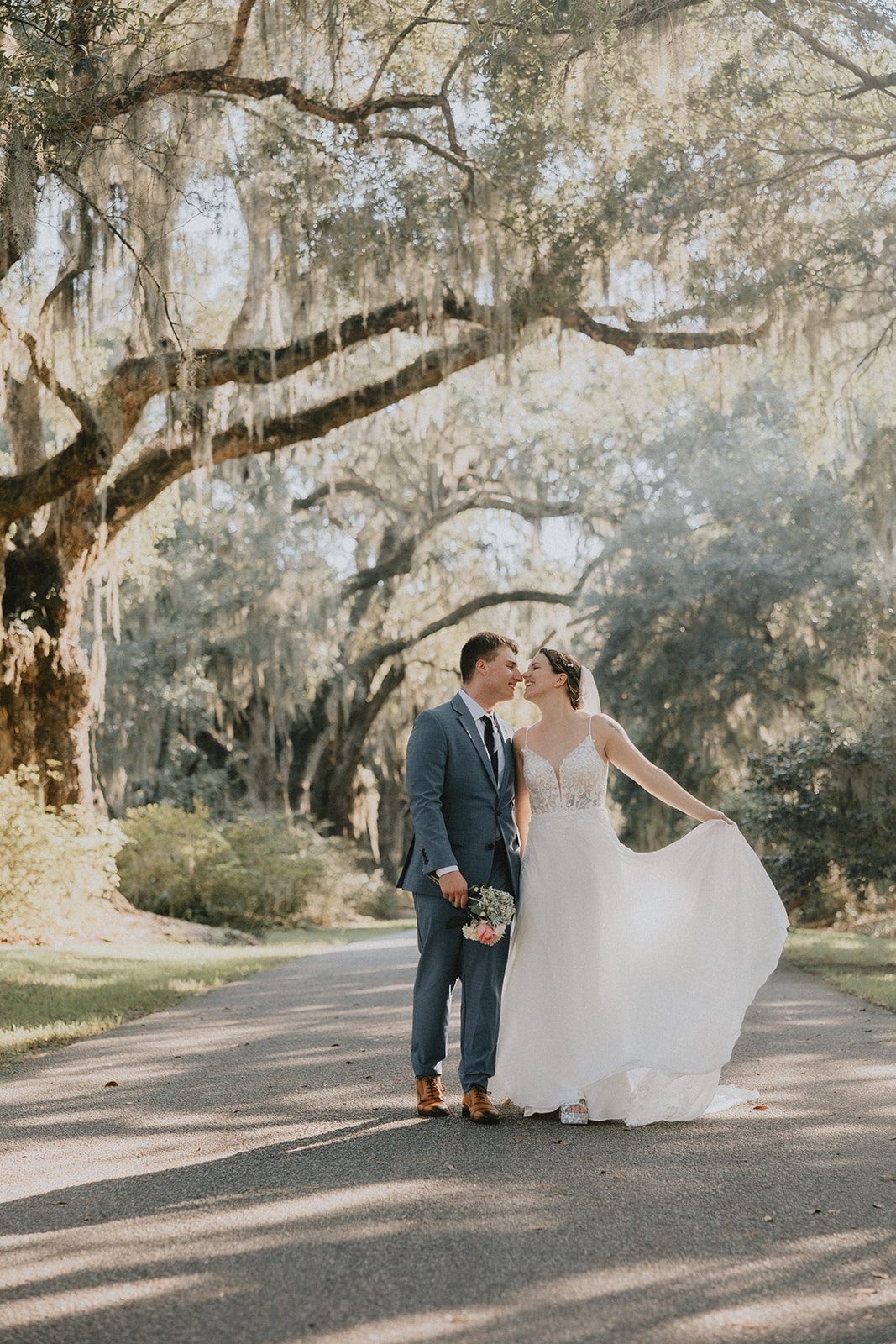 Bride and groom holding hands under the oaks Bride and groom holding hands under the oaks