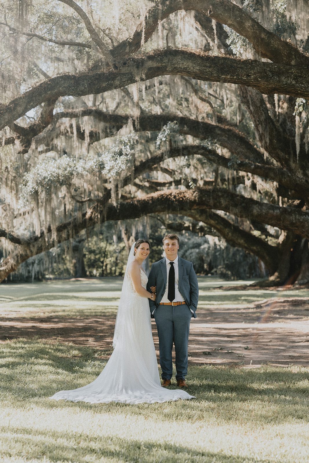 Couple standing under the oaks Couple standing under the oaks