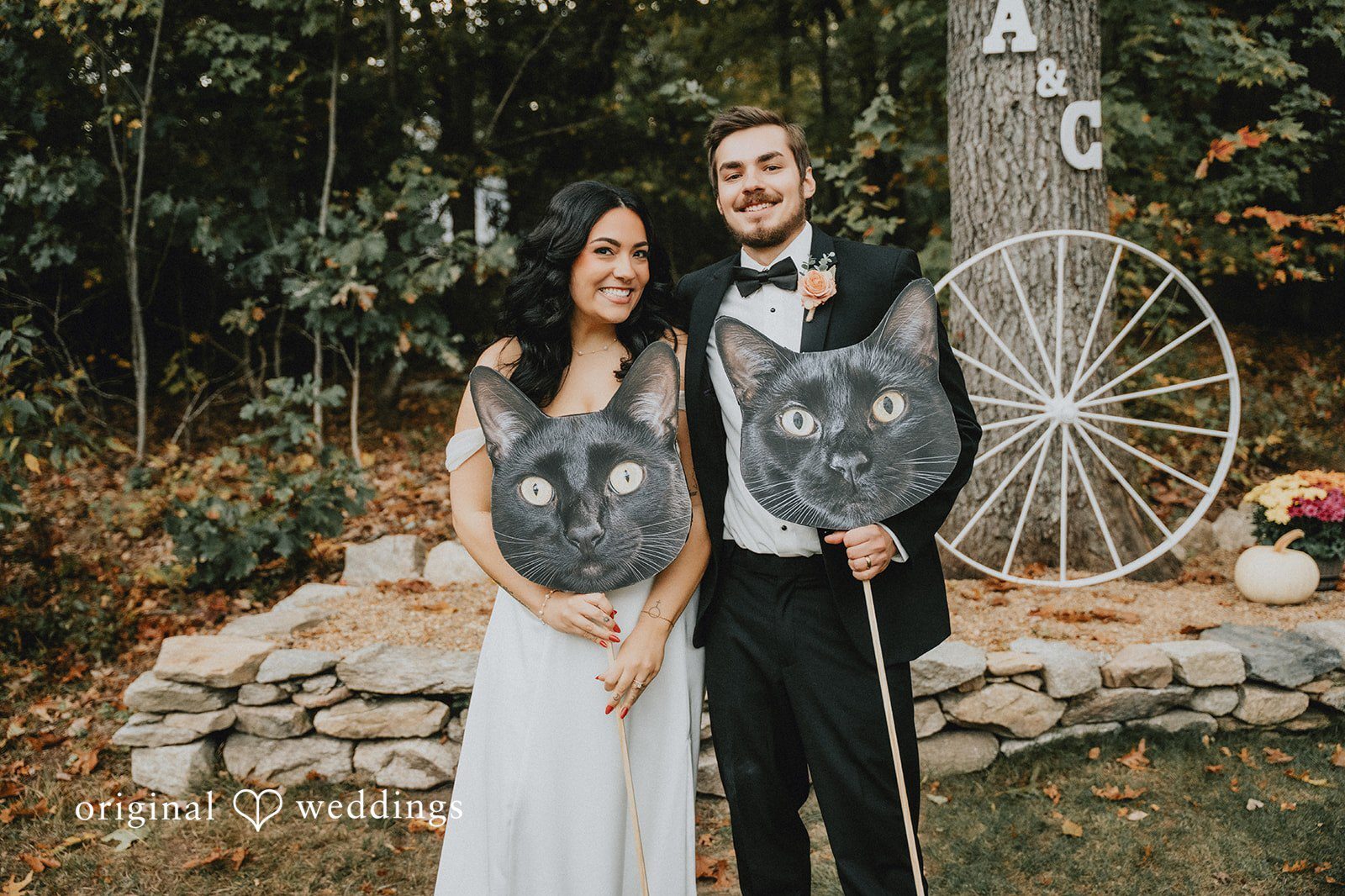 Our Boston wedding photographers captured a stunning portrait of the couple holding the images of their cats in their wedding Massachusetts backyard wedding