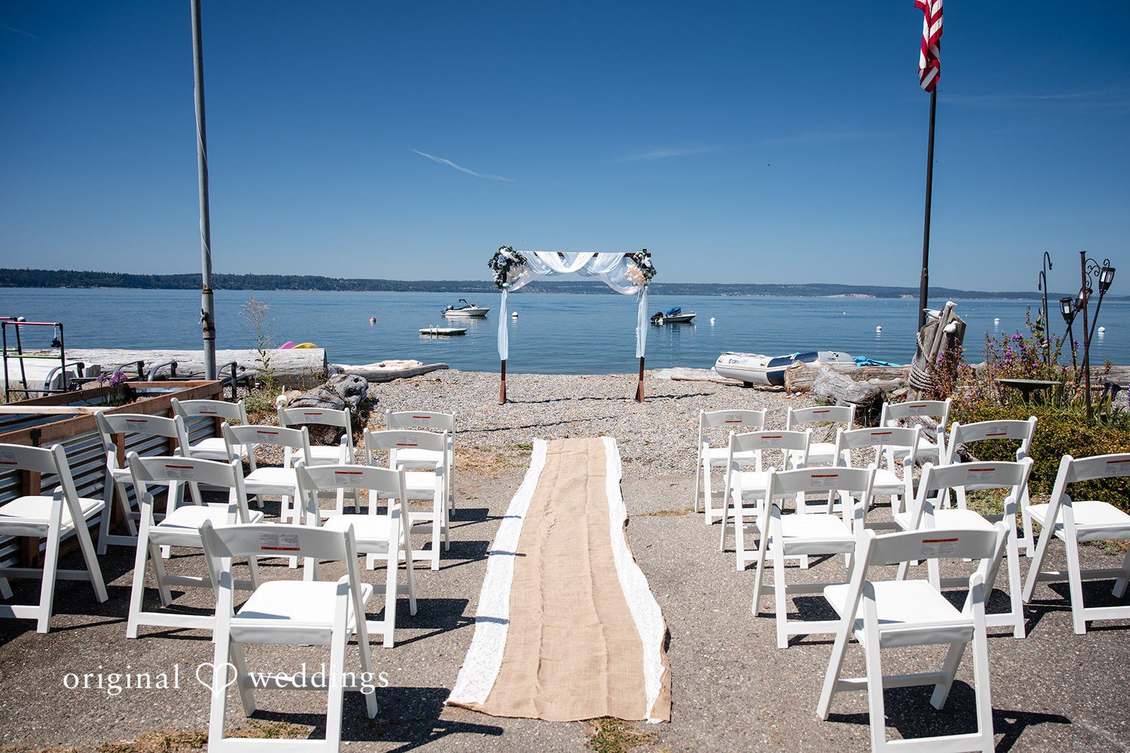 Kelly + John Ceremony chairs and aisle set up on the shore at Mckees Beach