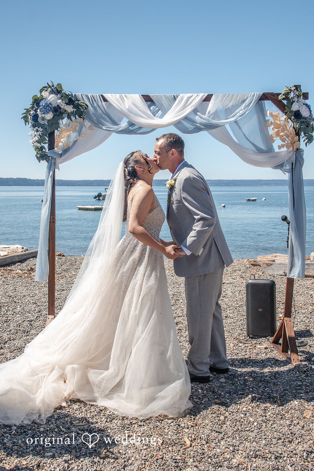Kelly + John Couple under the arch with sea views