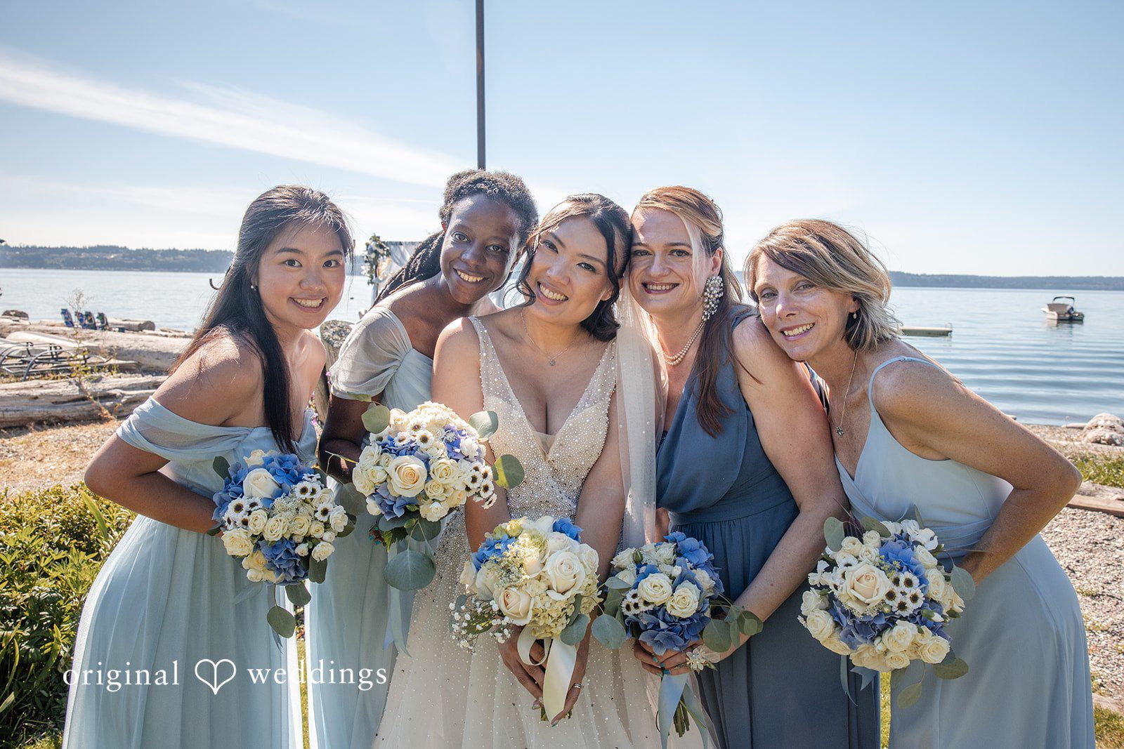 Kelly + John Bride laughing with her bridesmaids at Mckees Beach