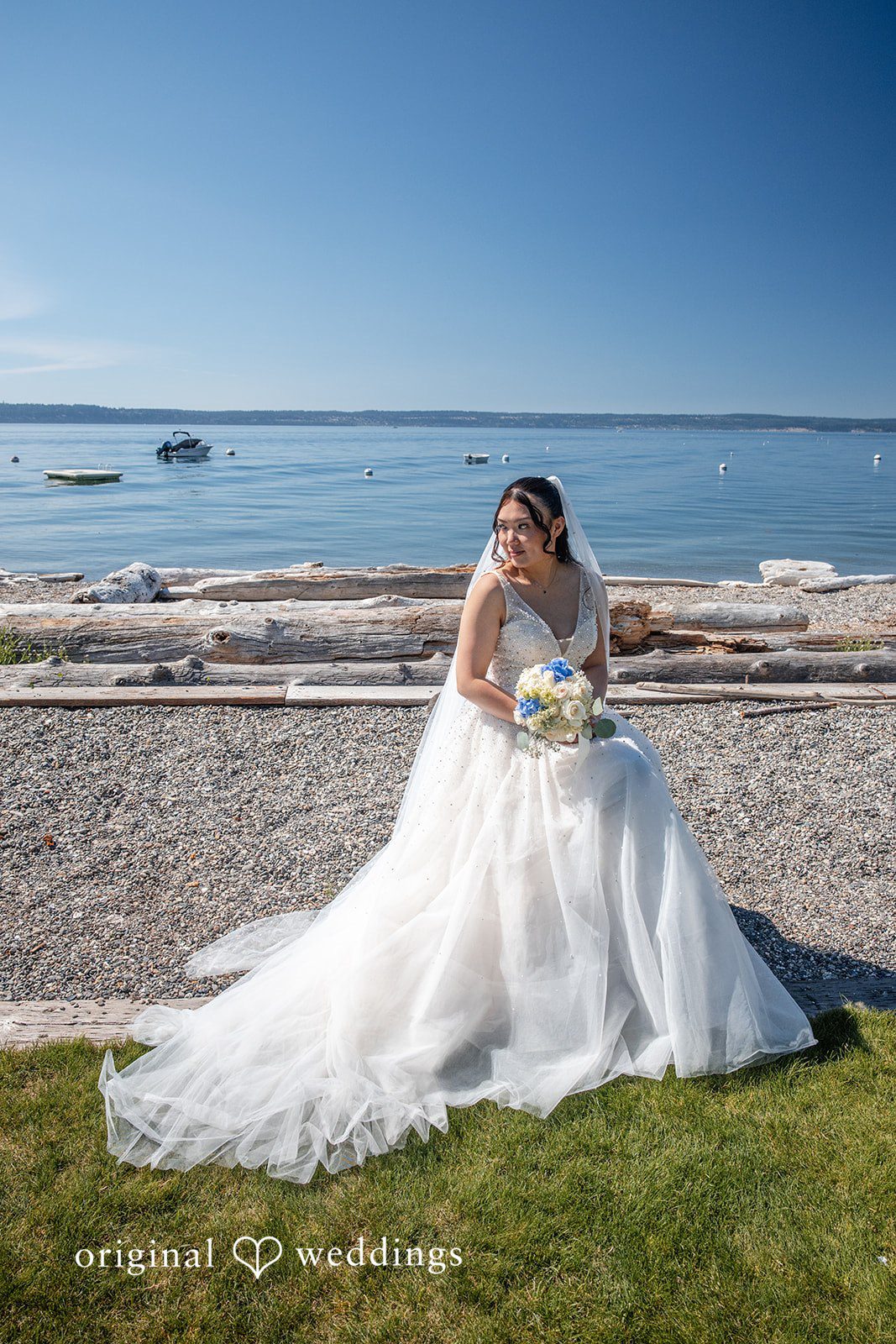 Kelly + John Bride standing on the beach at Mckees Beach