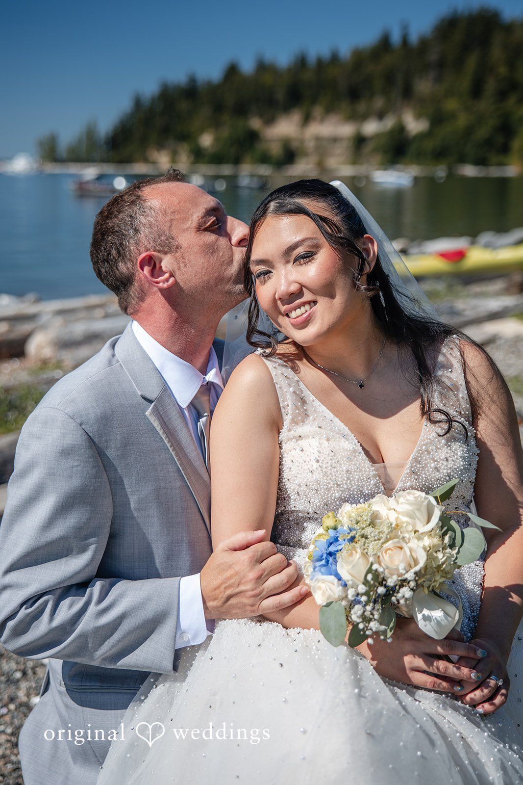 Kelly + John Groom kissing the bride on the cheek
