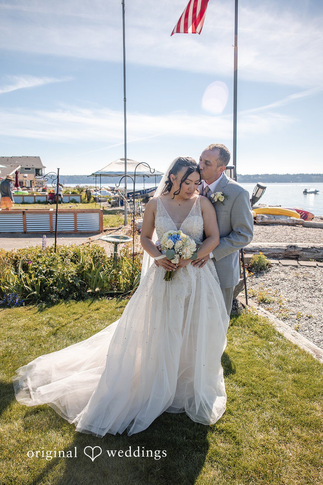 Kelly + John Couple sharing a kiss on the shore