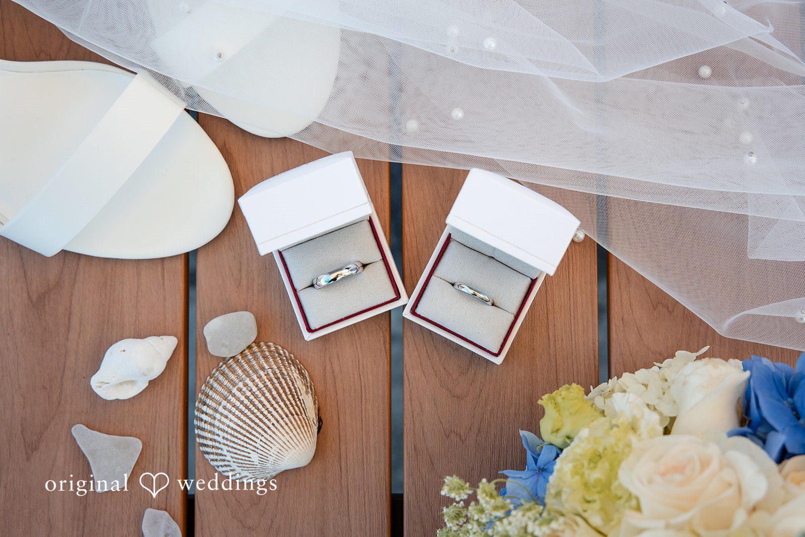 Kelly + John Wedding rings and details on a wooden table