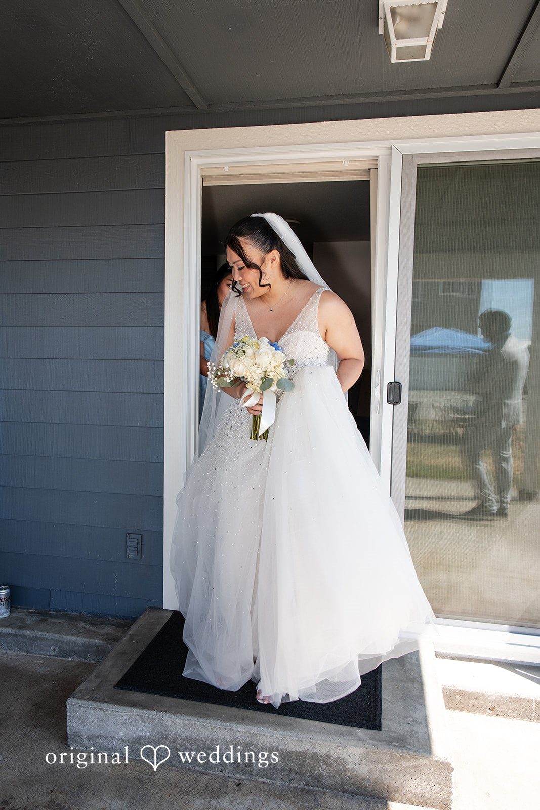Kelly + John Bride in a doorway before the ceremony