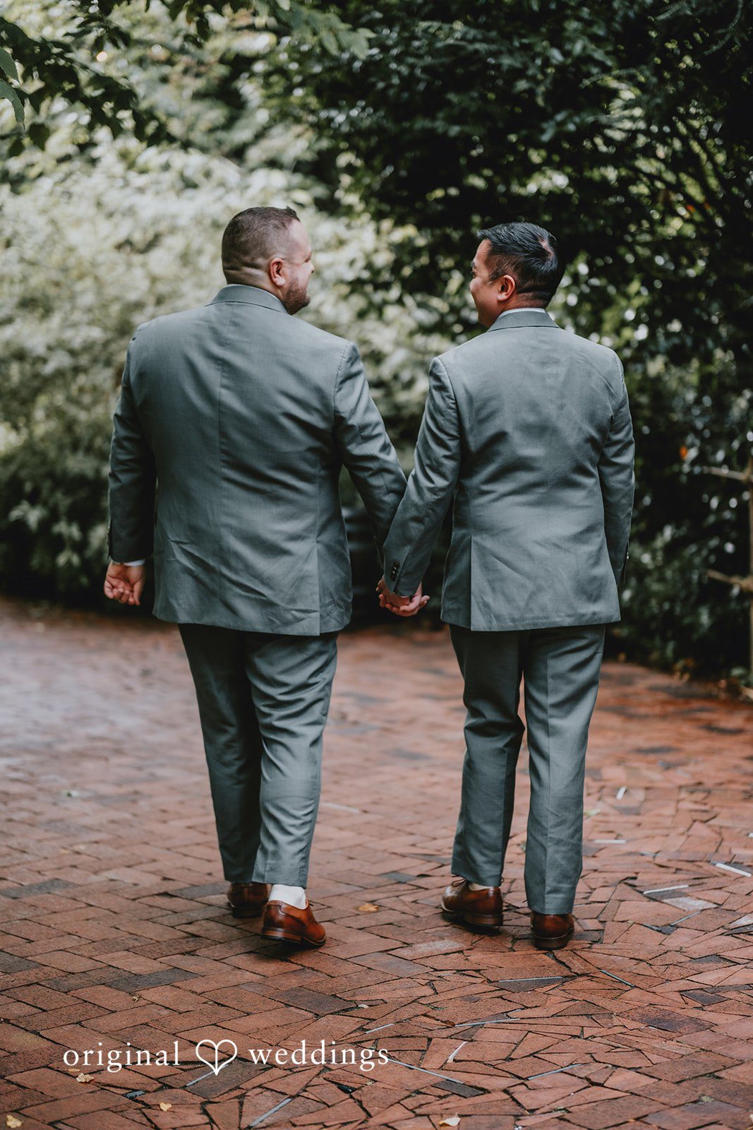 Benjamin + Tuan Couple walking hand in hand along the brick path