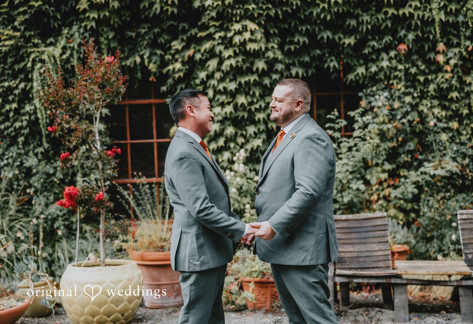 Benjamin + Tuan Grooms holding hands in the garden