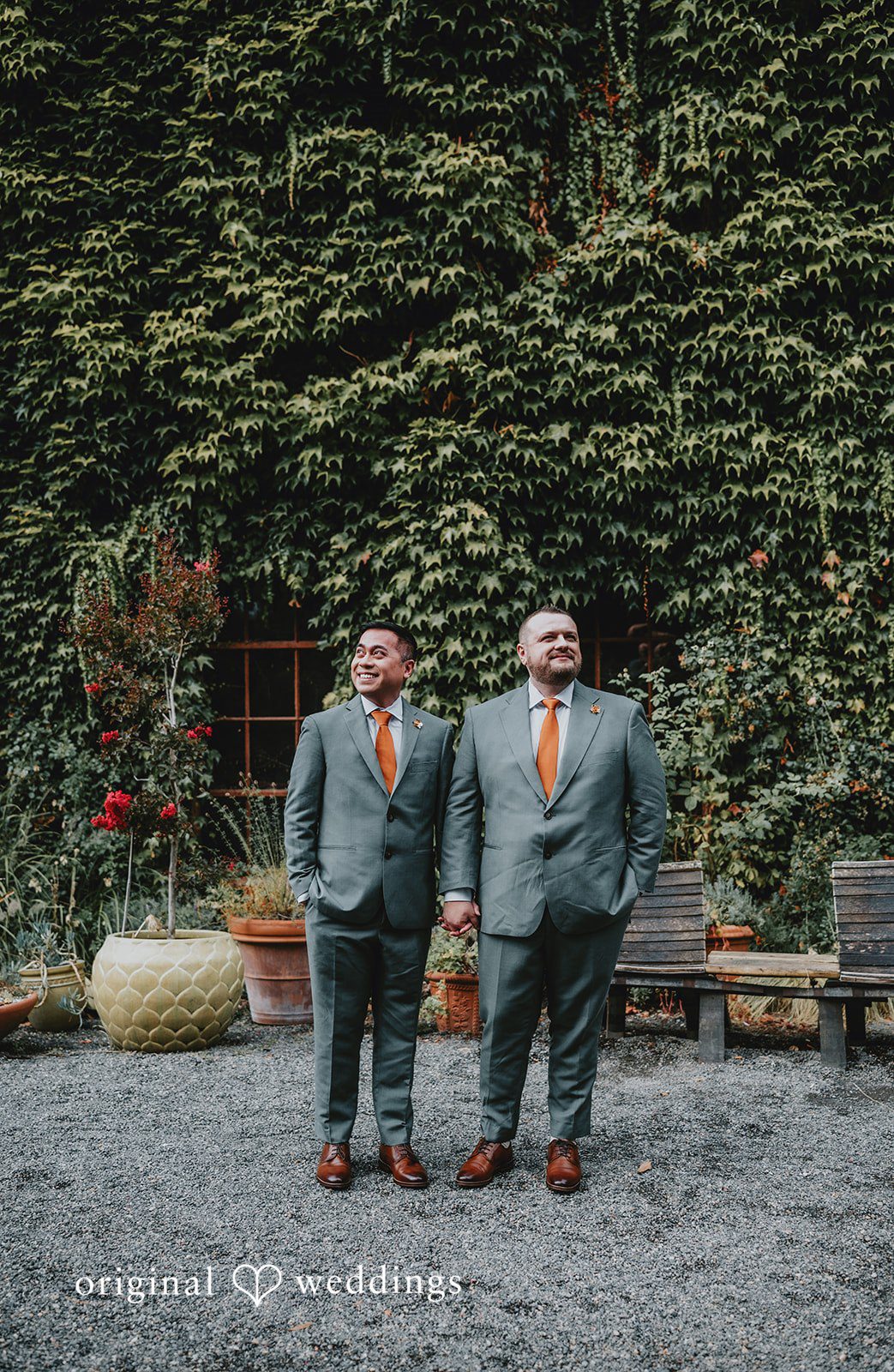 Benjamin + Tuan Couple posing in front of ivy covered walls