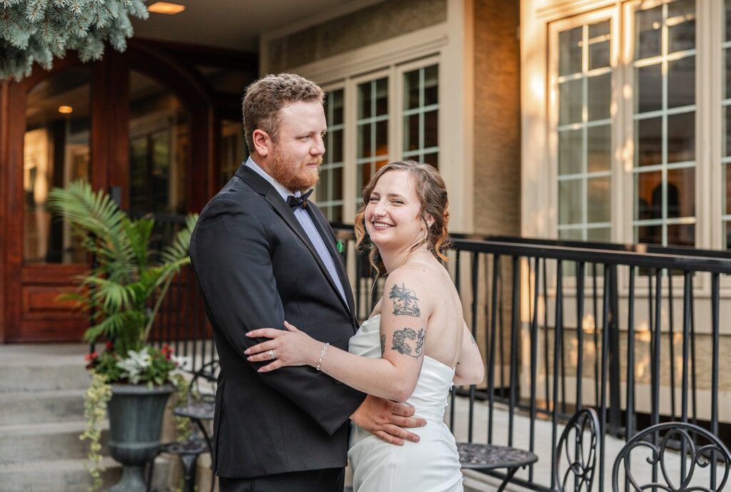 St. Paul College Club Wedding | Jassmyn & Johnny 7 Bride and groom smiling on the patio, captured by Minneapolis wedding photographers from Original Weddings at St. Paul College Club