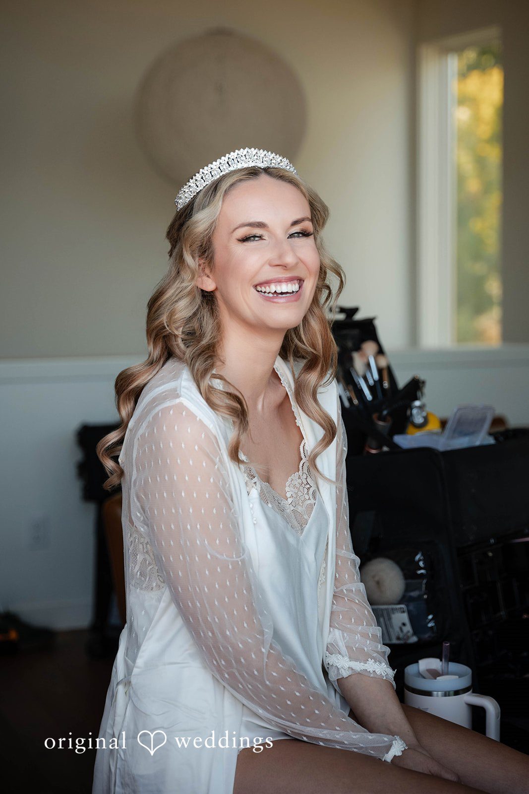 Bride smiling while getting ready