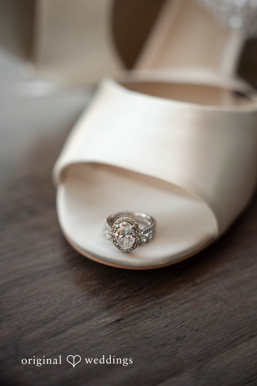 Wedding ring resting on a bridal shoe