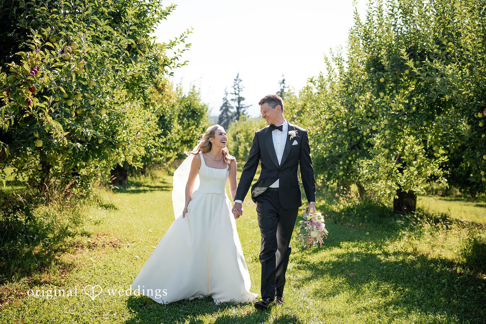 Couple walking back up the aisle as newlyweds at Mt View Orchards
