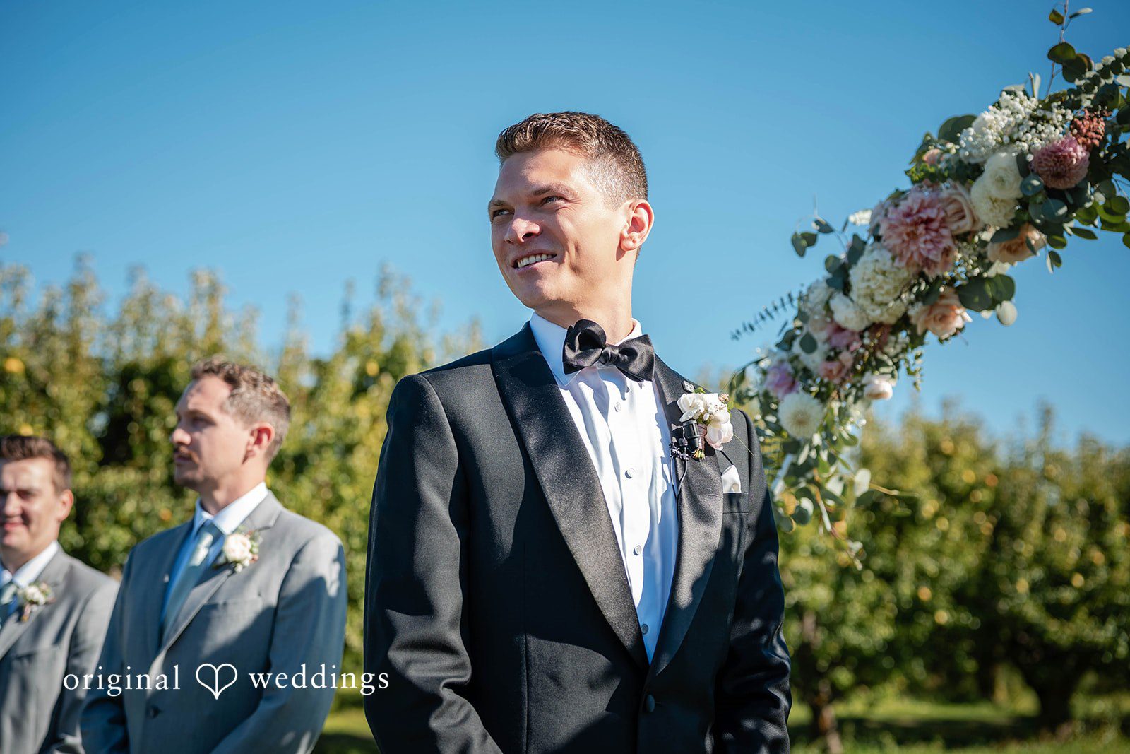 Groom with his groomsmen and a mountain view at Mt View Orchards