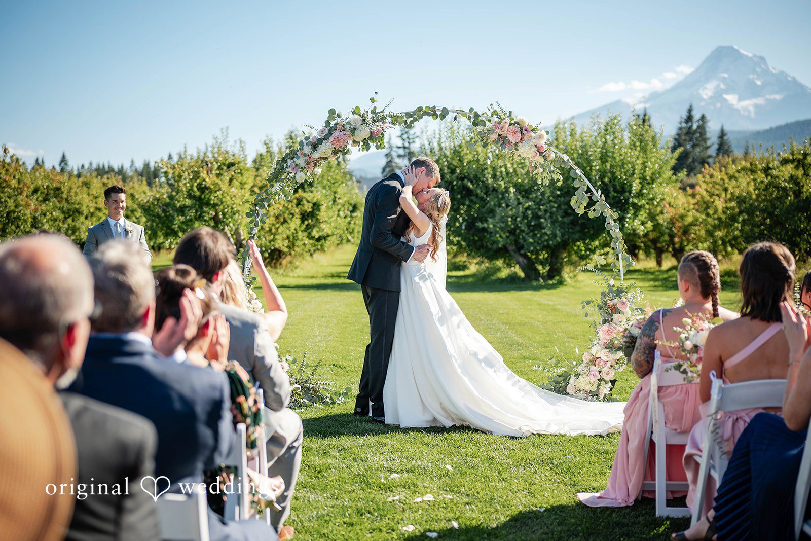 First kiss as guests cheer at the ceremony