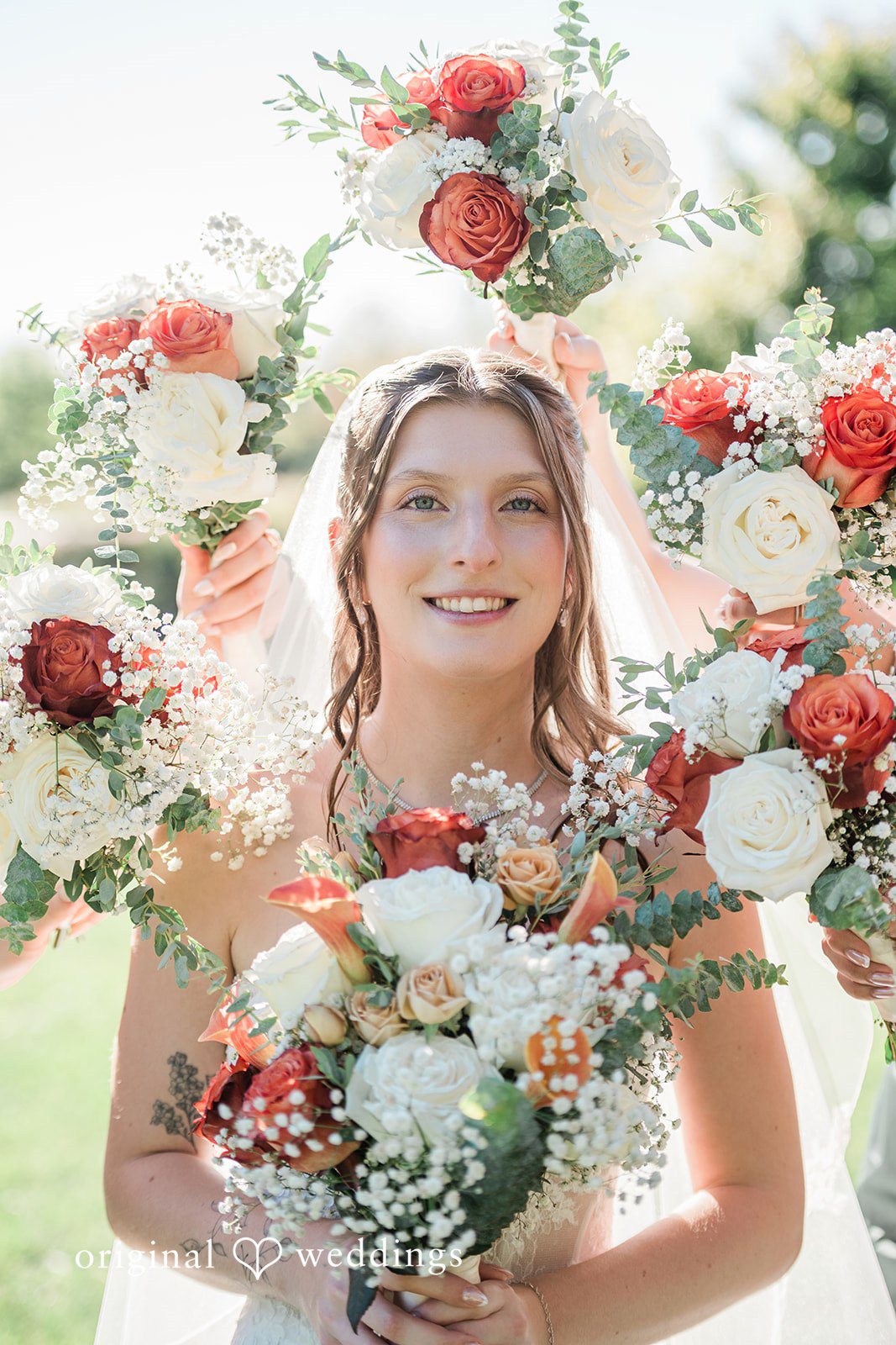 Kensey + Jordan Bride smiling with her bouquet at Muhlhauser Barn