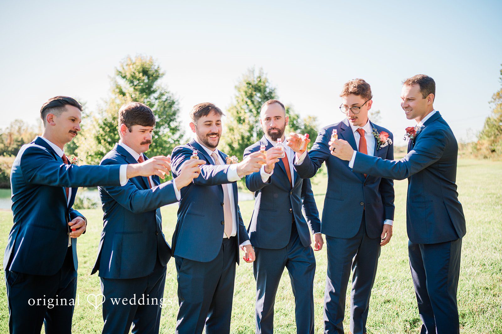 Kensey + Jordan Groom and groomsmen raising a toast