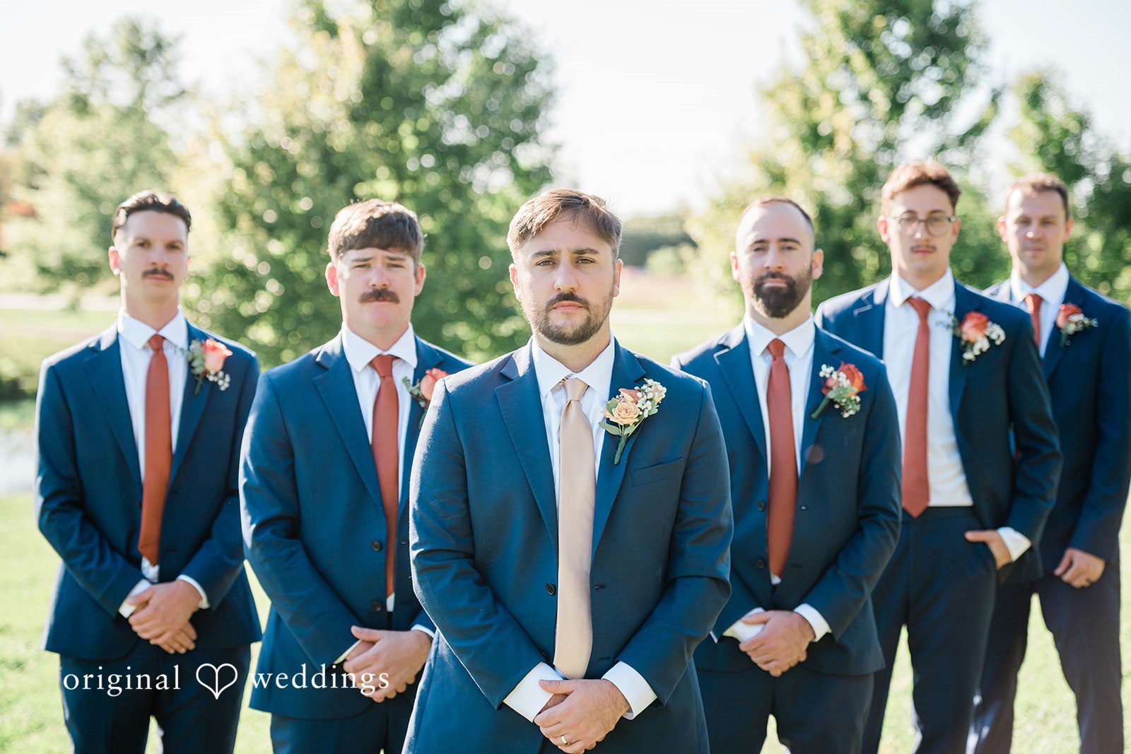 Kensey + Jordan Groomsmen lined up on the lawn at Muhlhauser Barn