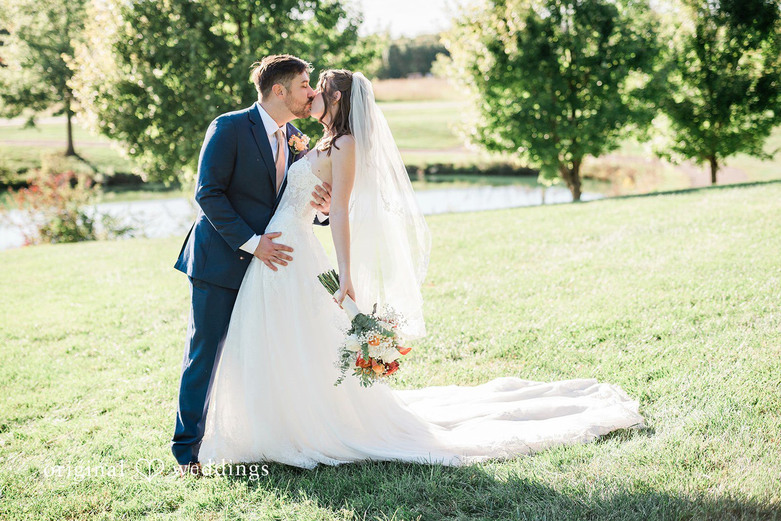 Kensey + Jordan Couple sharing a kiss on the lawn