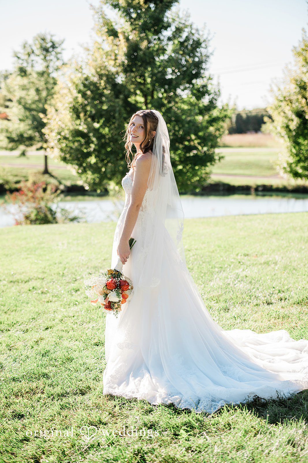 Kensey + Jordan Bride showing off her gown from behind