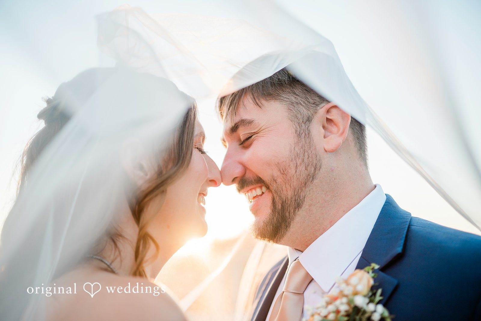Kensey + Jordan Bride and groom smiling under her veil, captured by Cincinnati wedding photographers from Original Weddings at Muhlhauser Barn