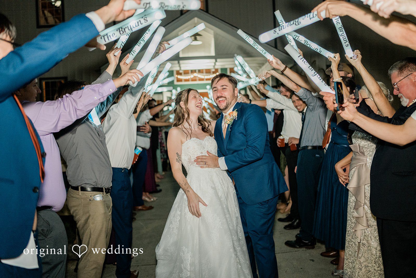 Kensey + Jordan Couple's grand entrance with arms raised by guests