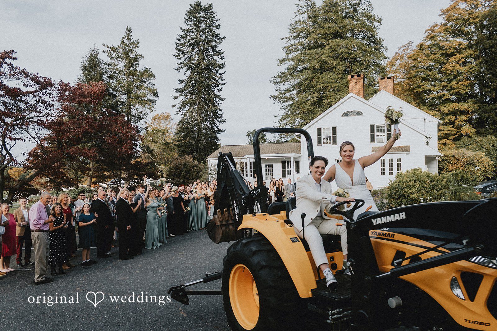 Our Hartford CT wedding photographers at Original Weddings captured the couple joyfully riding a farm tractor at New Pond Farm