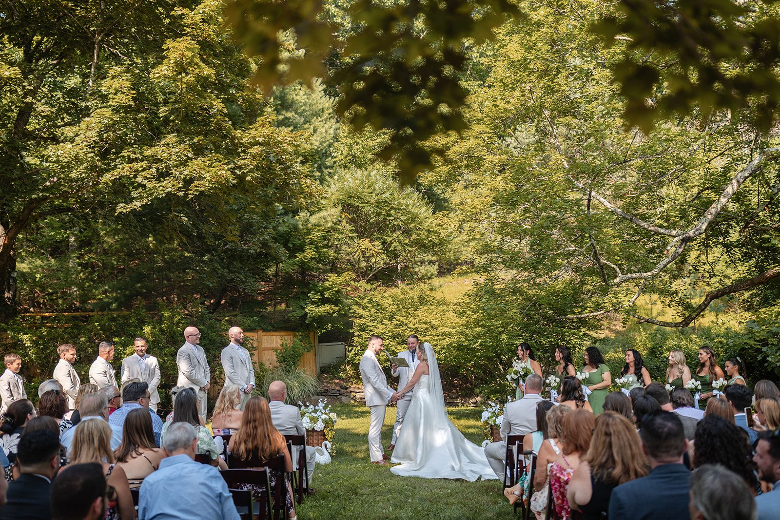 new-york-backyard-timeless-new-york-taylor-andrew-p012-08 Guests watching the outdoor ceremony at a New York backyard wedding