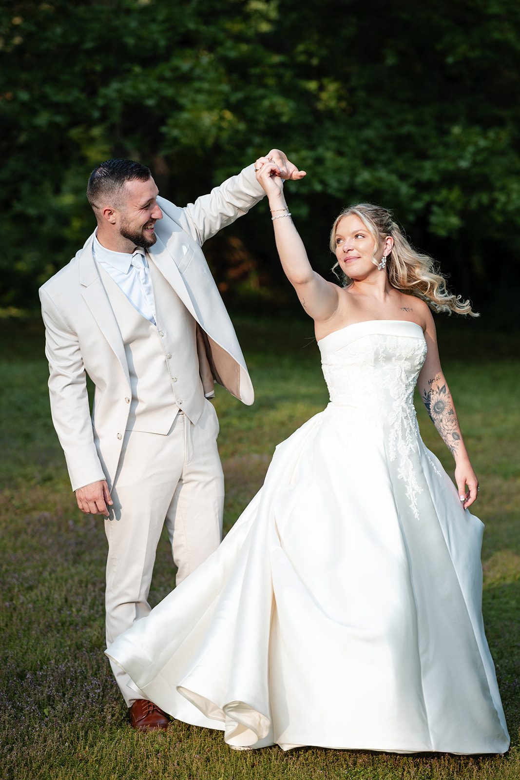 new-york-backyard-timeless-new-york-taylor-andrew-p019-17 Groom twirling the bride on the lawn at a New York backyard wedding