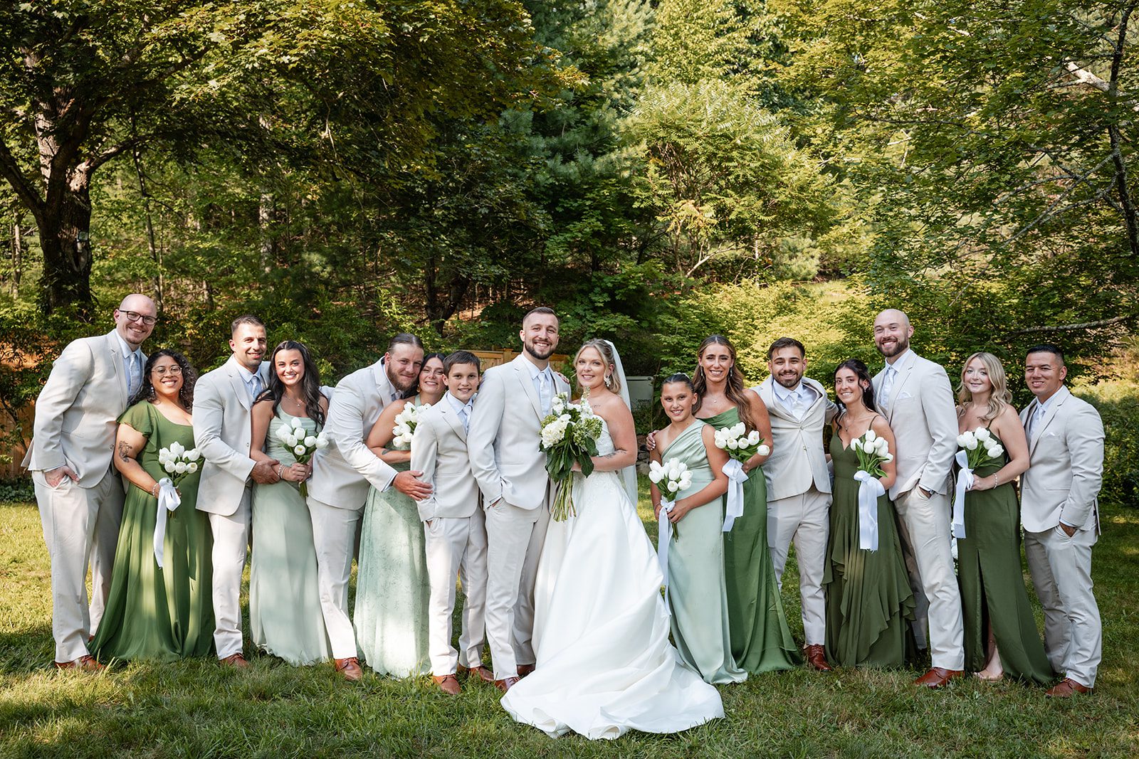 new-york-backyard-timeless-new-york-taylor-andrew-p021-14 Wedding party in sage green gathered on the lawn at a New York backyard wedding